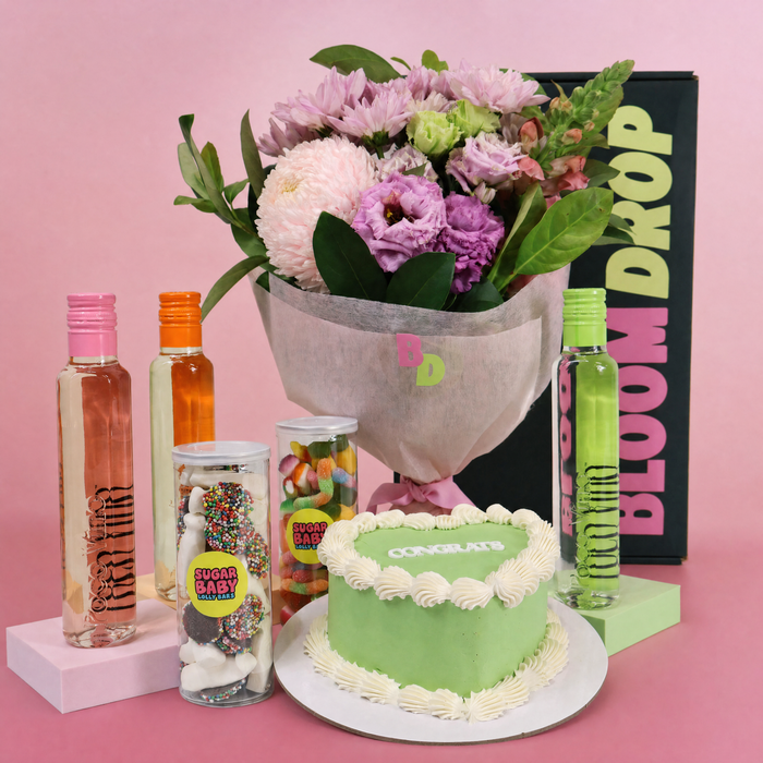 Celebration gift hamper Sydney with flowers, heart cake, mini wines and lolly jars