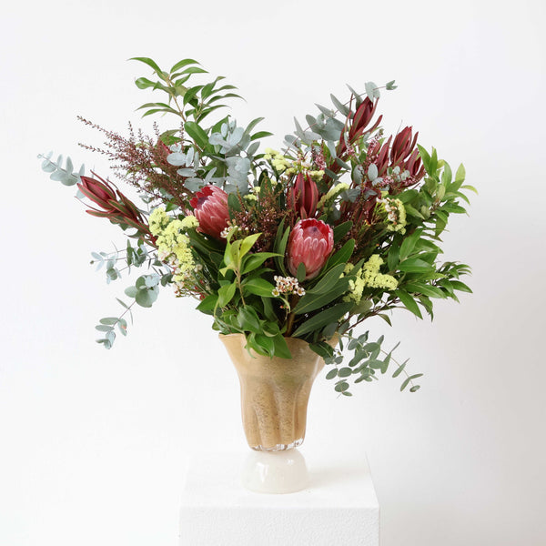 Australian native flower arrangement with pink protea, eucalyptus, leucadendron and seasonal foliage