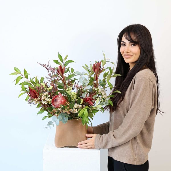 Australian Native Bouquet featuring protea, leucadendron, wax flower, eucalyptus, tea-tree, and lemon myrtle in natural tones