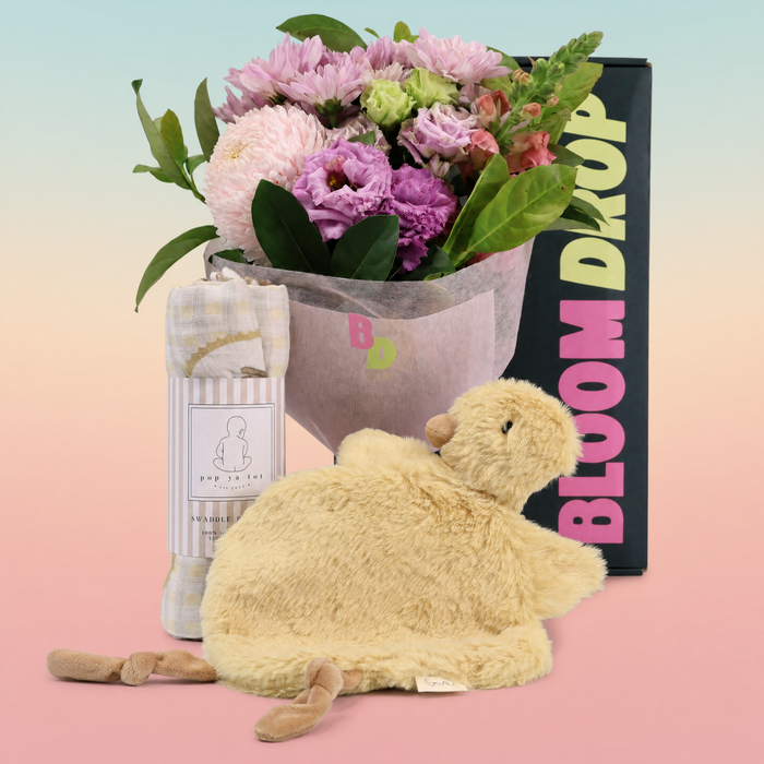 New baby gift hamper Sydney with florist choice flowers, organic cotton swaddle and duck comforter