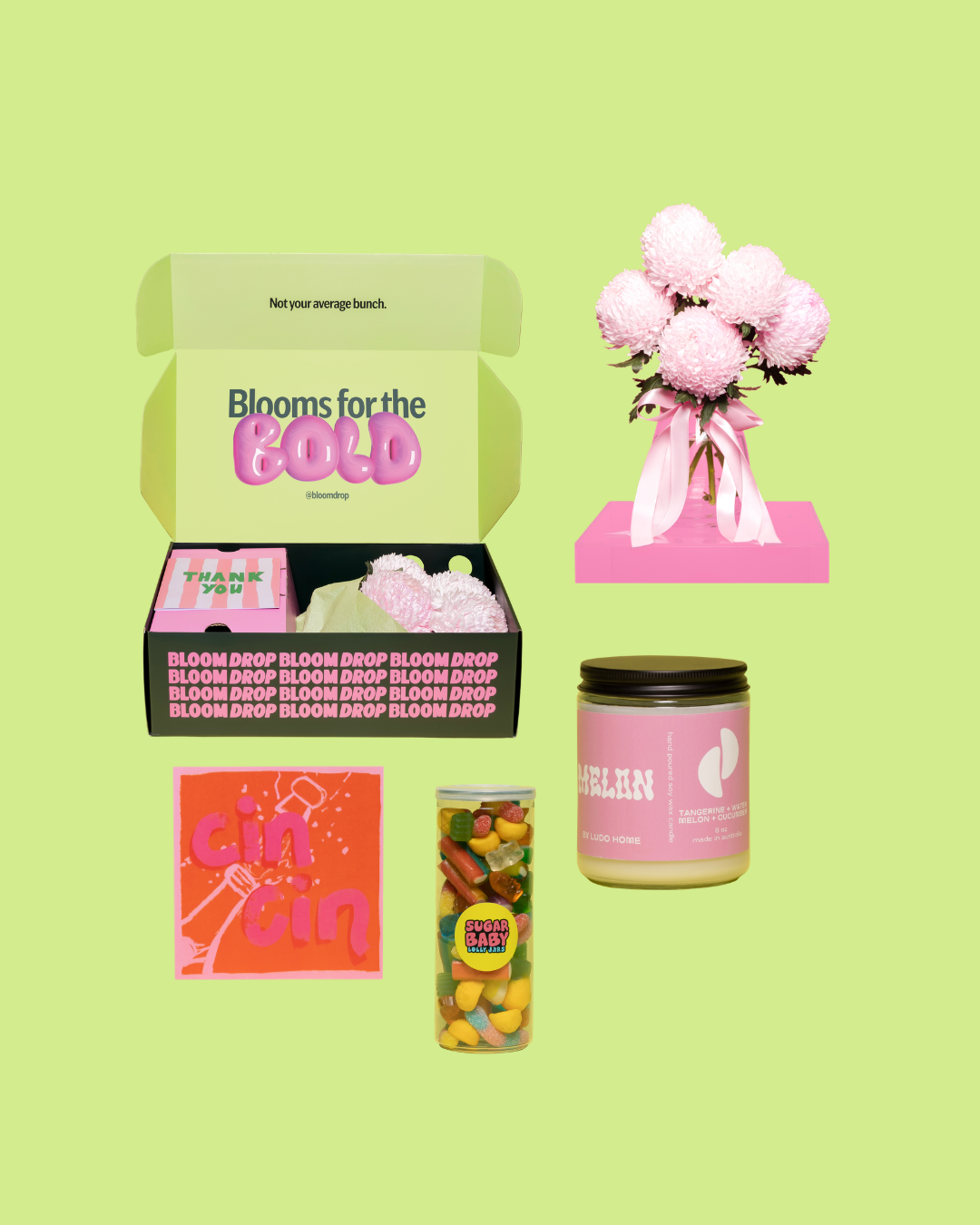 Collection of products including a box, candle, candy, and flowers on a green background