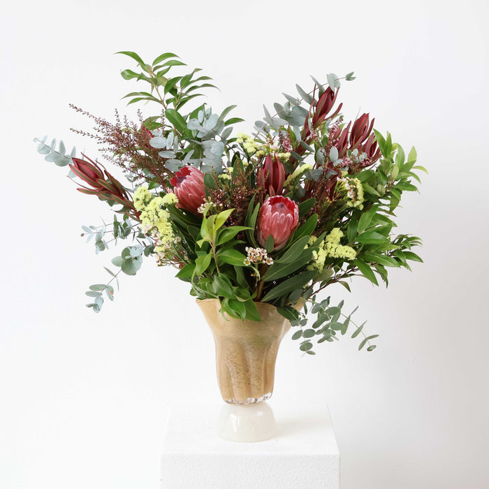 Australian native flower arrangement with pink protea, eucalyptus, leucadendron and seasonal foliage
