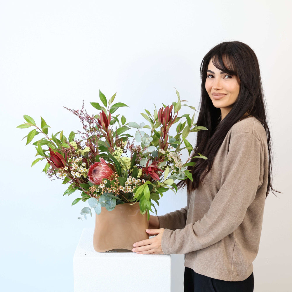 Australian Native Bouquet featuring protea, leucadendron, wax flower, eucalyptus, tea-tree, and lemon myrtle in natural tones