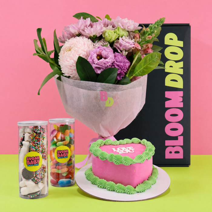 Pink birthday hamper with fresh flowers, heart cake and sweet treats by Bloom Drop Sydney